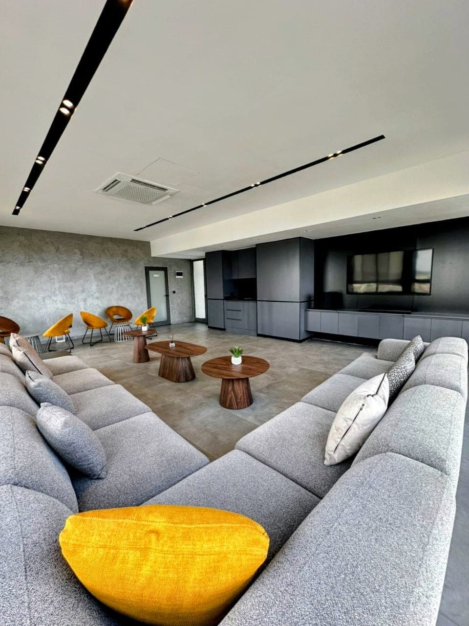 Light-filled residential lounge with contemporary seating and gold accents